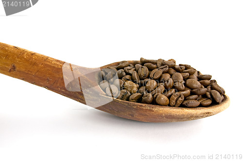 Image of wooden spoon with coffee beans 