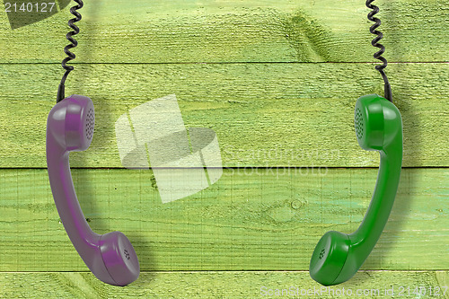 Image of handsets hung against wooden wall