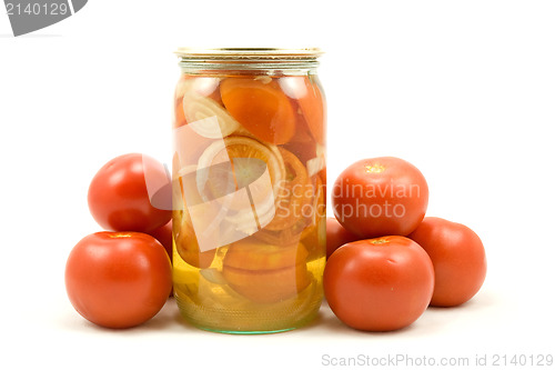 Image of The clear glass jar of pickled tomatoes