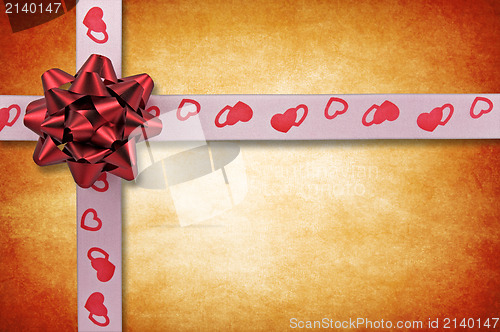 Image of ribbon with bow on grunge background