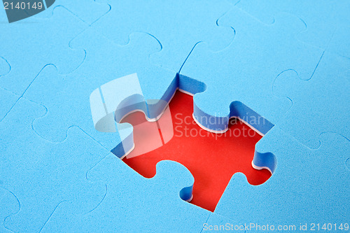 Image of blue puzzle  with one piece missing