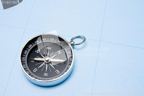 Image of  compass on blue paper background