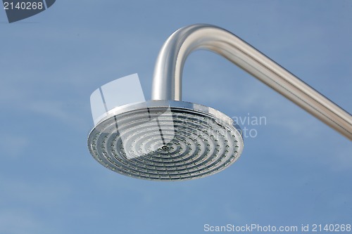Image of close up on head shower in a blue sky