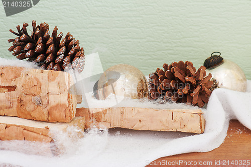Image of abstract composition from birch logs, Christmas balls and cones