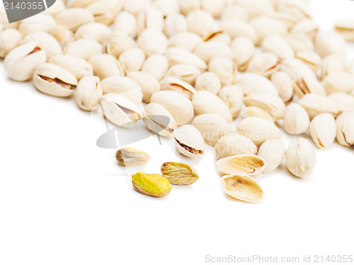 Image of dry salted pistachios on white background