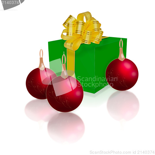 Image of green gift box with gold ribbon and bow and Christmas balls isol