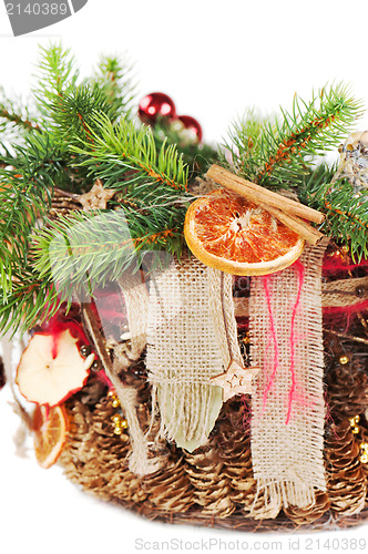 Image of Christmas-tree branch decorated with balls, beads, cinnamon and 