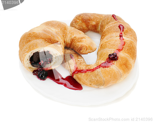 Image of croissant with chocolate and raspberry jam on plate isolated on 