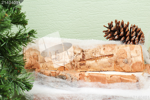 Image of abstract composition from fir branches and birch logs