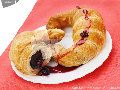 Image of fresh and tasty croissants with chocolate and raspberry jam on p