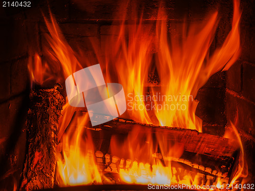 Image of fireplace with wood and fire