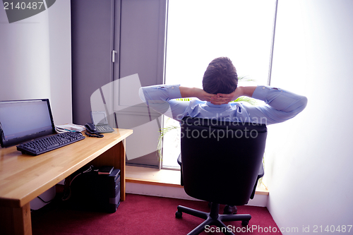 Image of happy young business man at office
