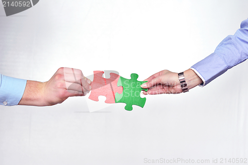 Image of Group of business people assembling jigsaw puzzle