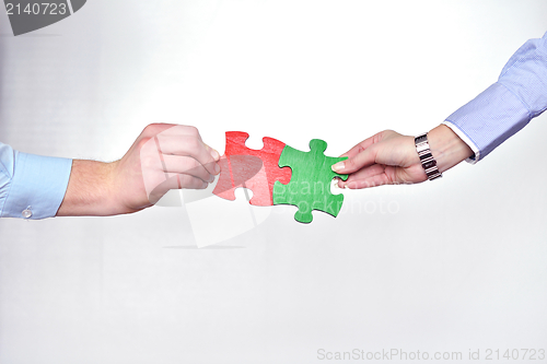 Image of Group of business people assembling jigsaw puzzle