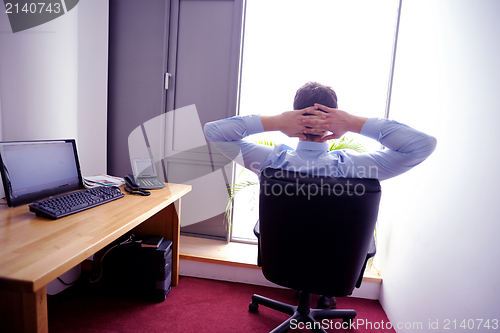 Image of happy young business man at office