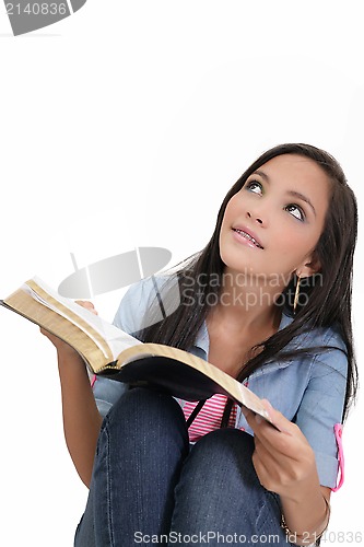 Image of Beautiful young woman holding a Bible