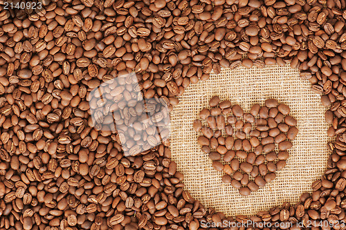 Image of heart coffee frame made of coffee beans on burlap texture 