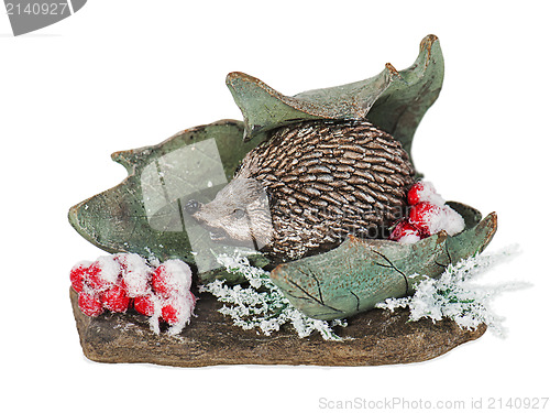 Image of Christmas composition of hedgehog, mountain ash, stone and leaf 