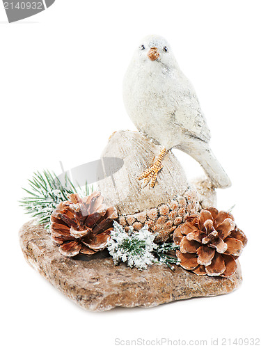 Image of Christmas arrangement of bird on a nut with cones, pine needles 