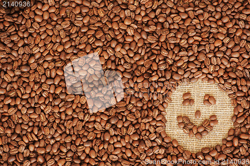 Image of face coffee frame made of coffee beans on burlap texture 