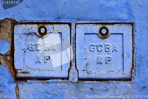 Image of two metal box and a blue broken wall