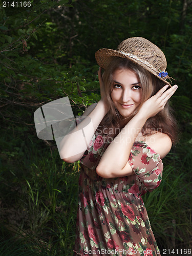 Image of Beautiful girl in the national dress and hat stand in the  fores