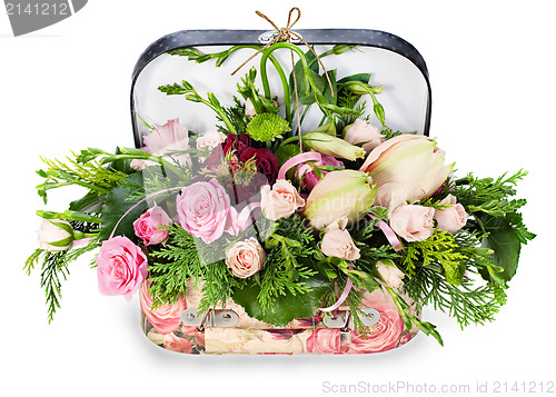 Image of a colorful floral arrangement of roses and lilies in acardboard 