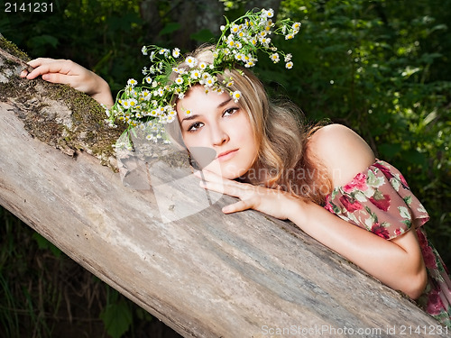 Image of Beautiful girl in the national dress and and a wreath stand in t