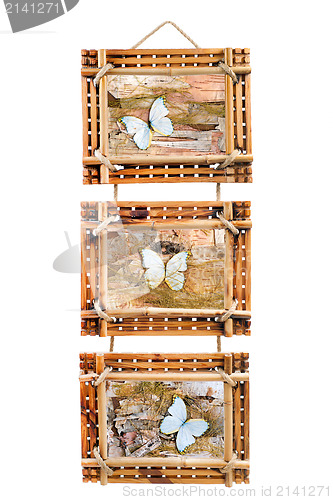 Image of three bamboo photo frames with abstract composition of butterfli