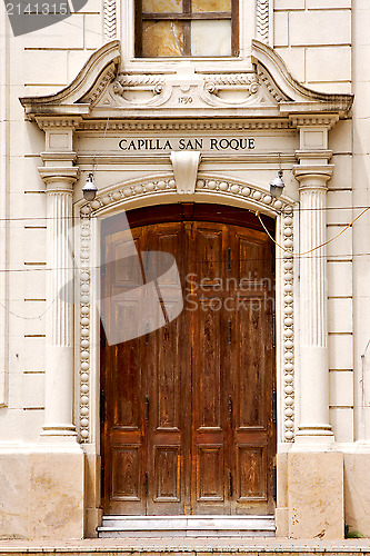 Image of brown wood old door of a church capilla san roque 