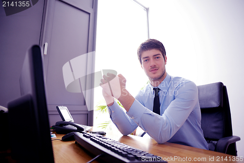 Image of happy young business man at office