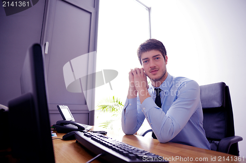 Image of happy young business man at office
