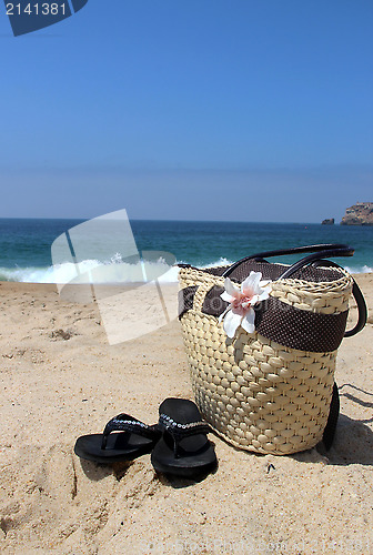 Image of Seacoast and straw beach bag