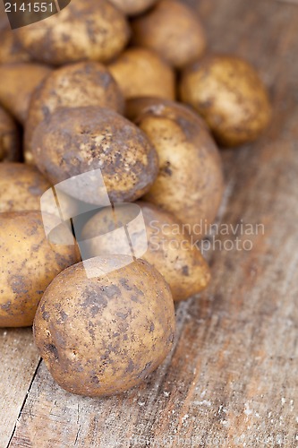 Image of potatoes on a wooden background