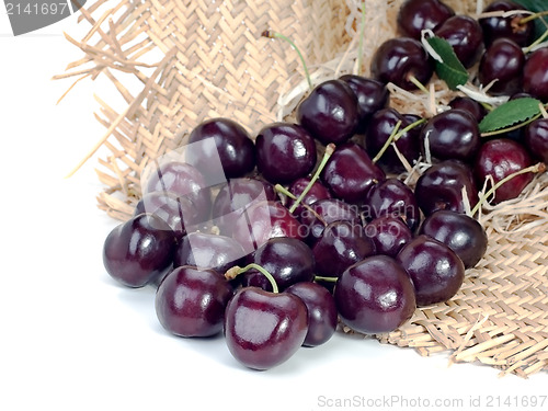 Image of sweet cherry in a straw hat isolated on white background 