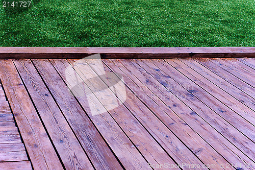 Image of Fresh spring green grass with wood floor 