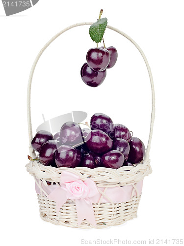 Image of sweet cherry in a wicker gift basket isolated on white backgroun