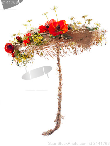 Image of decorative umbrella of burlap, mats and artificial flowers poppy