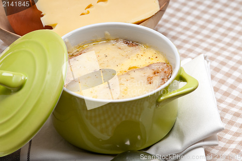 Image of oinion soup with melted cheese and bread on top