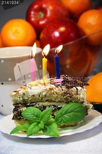 Image of Birthday cake with burning candles 