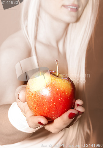 Image of hand that suggests to take apple