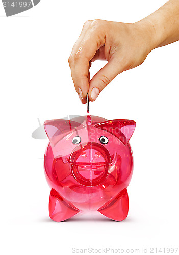 Image of hand putting coin into piggy bank