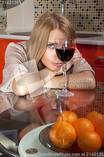 Image of woman in shine dress with glass of wine