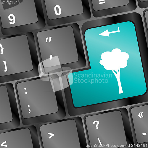 Image of Computer keyboard with abstract tree key - holiday concept
