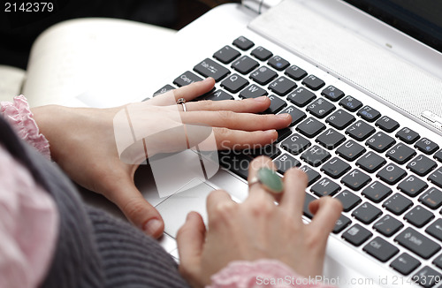 Image of Young woman working on laptop