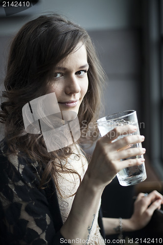 Image of Young Woman Drinking a Pint Glass of Ice Water