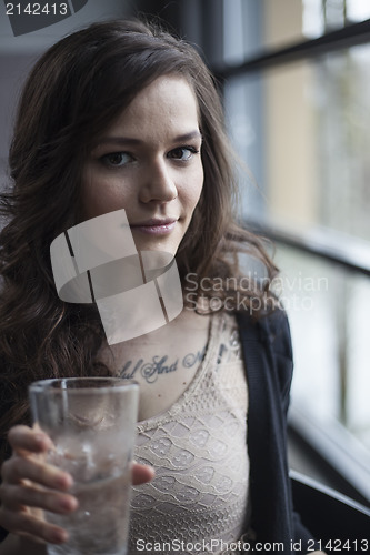 Image of Young Woman Drinking a Pint Glass of Ice Water