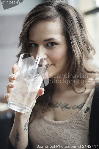 Image of Young Woman Drinking a Pint Glass of Ice Water