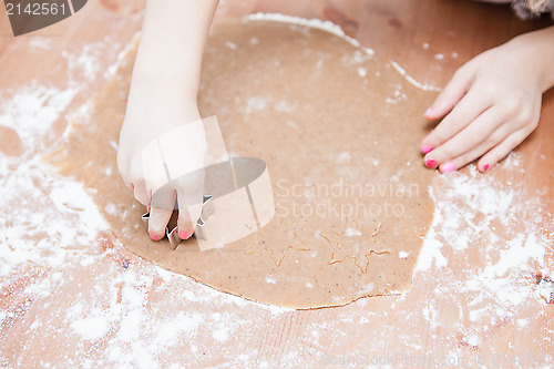 Image of Cutting gingerbread shapes from dough