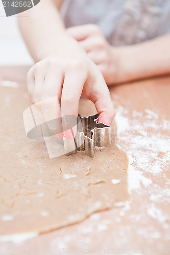 Image of Cutting gingerbread shapes from dough